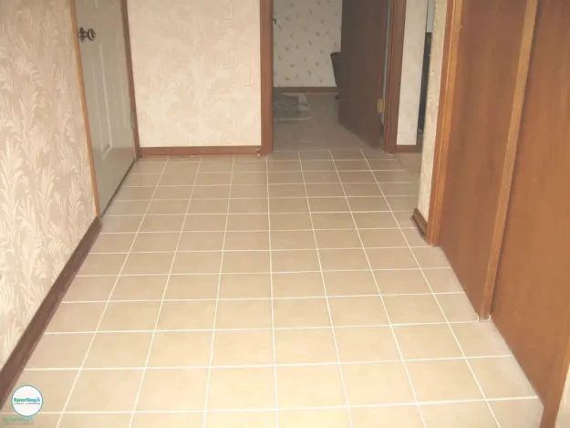 Clean beige ceramic tile hallway with bright, even grout lines after professional tile and grout cleaning